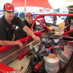 Peter Caughey (left) working on the red rocket motor in search of more power before Sunday's Meremere championship round
